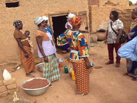Trickle Up participants at home with dried millet and sorghum