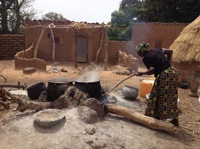 A program participant brewing sorghum beer to sell in markets and from her house